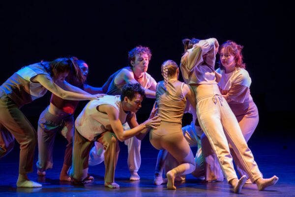 A group of students perform a modern dance piece