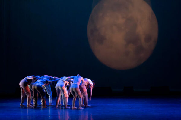 A group of students perform a modern dance piece